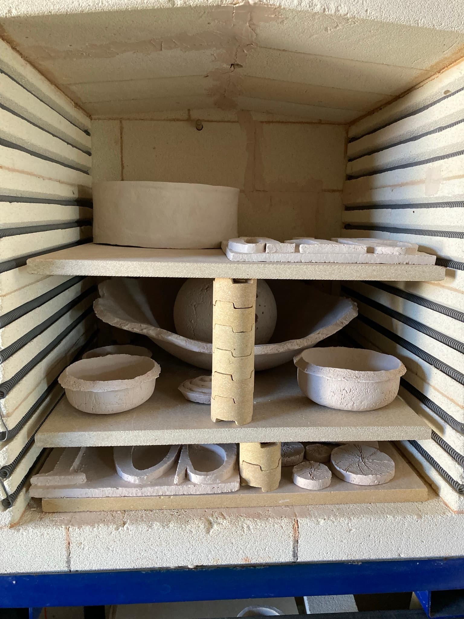 After drying, first biscuit firing at 1,020°C